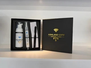Jewelry cleaning supplies in a branded Ashland City Jewelers and Pawn presentation box