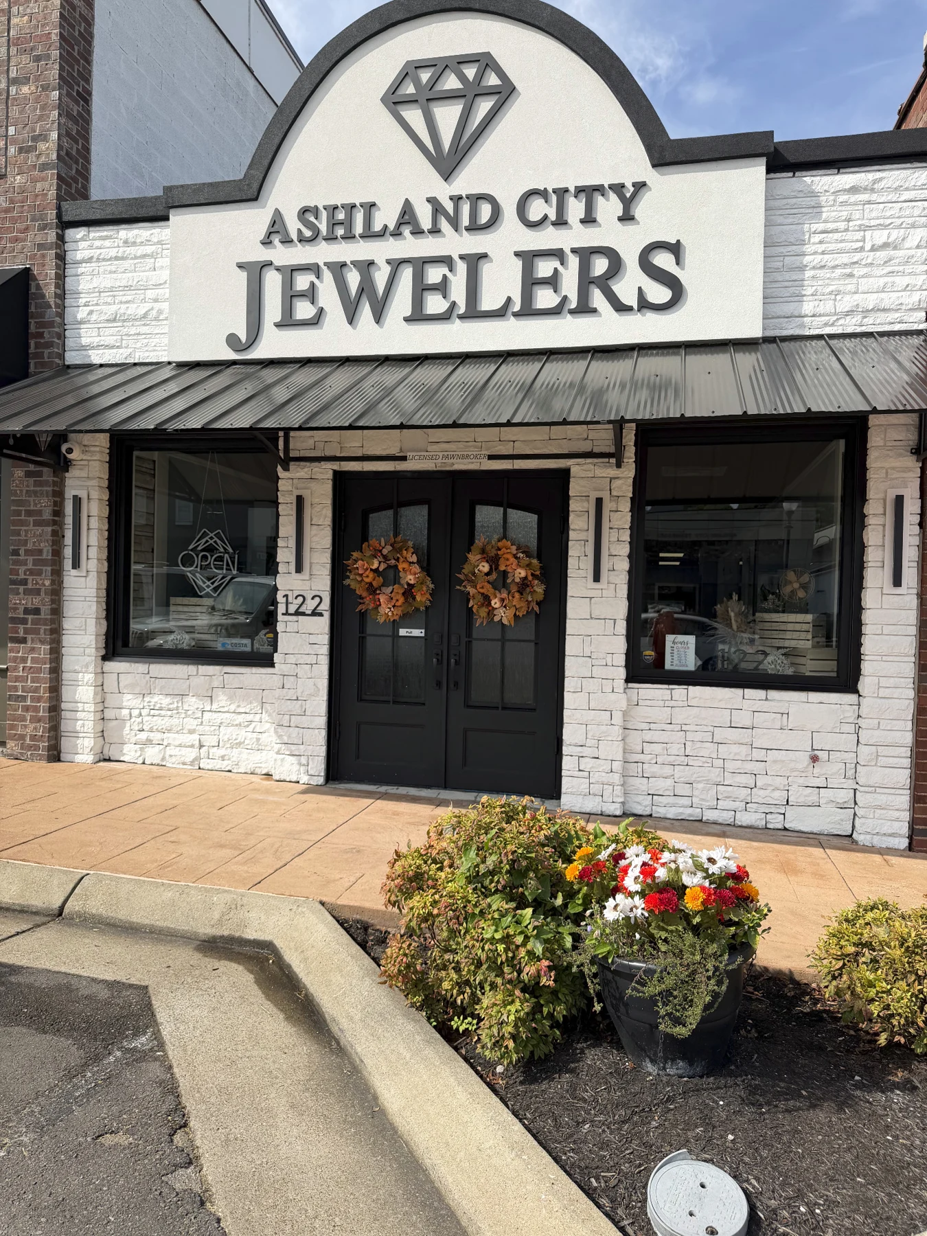 Our Main Street storefront decorated for fall